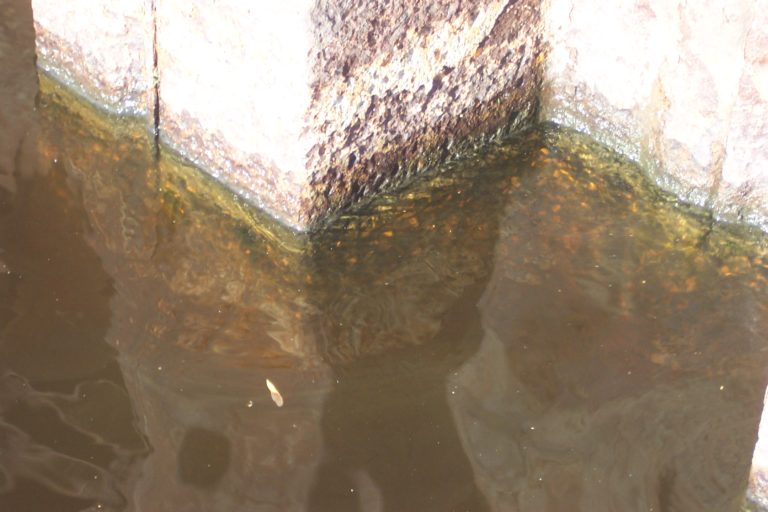 Cubical steel piling covered in rust