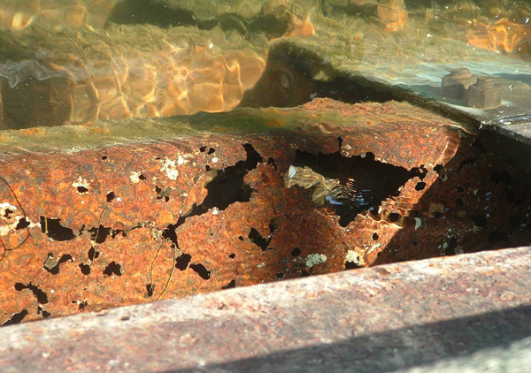 Horizontal box beam showing surface destroyed by rust holes