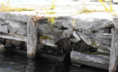 Image showing a wooden retaining crib failing with rotted and missing pieces of wood